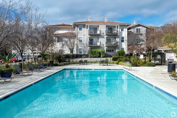 A swimming pool in front of a residential building.